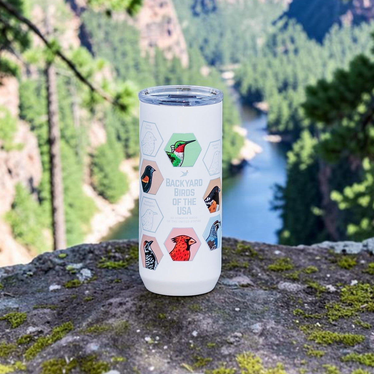 Beakwings white stainless steel Spotter Tumbler featuring colorful bird stickers inside laser-engraved hexagon outlines.